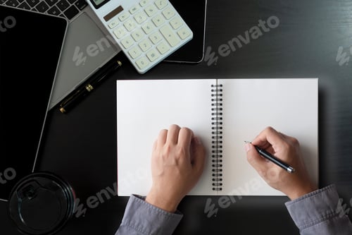 Preview: Male hands working on notebook. Office desktop on black background.