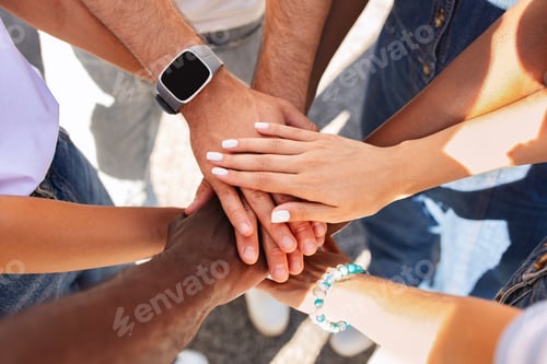 Preview: Cropped of multiracial people holding hands on top each other