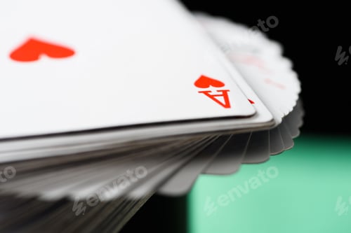 Preview: selective focus of ace playing card with hearts suit in deck on green background