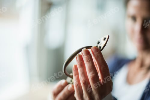 Preview: An antiques store in a small town, with objects and furniture, woman holding a door handle