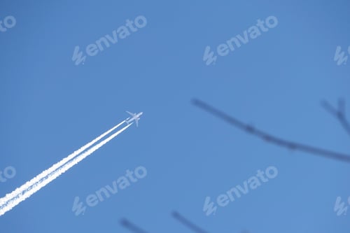 Preview: A jet plane in the sky. a double track from a jet plane in a blue sky.