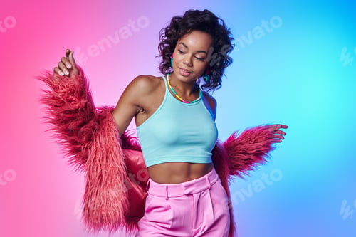 Preview: Beautiful African woman in fluffy jacket standing against colorful background