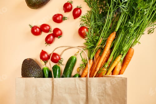 Preview: Flat lay vegetables, carrots, cucumbers, avocados, tomatoes in a paper bag for shopping
