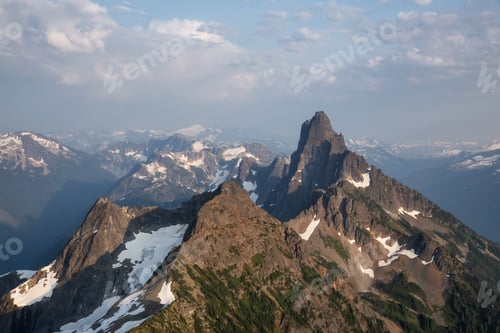 Preview: Aerial view of the rugged Canadian Mountain Landscape during a summer evening