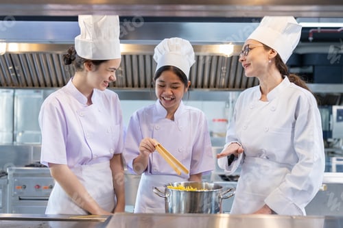 Preview: Chef instructor teaching students in kitchen class