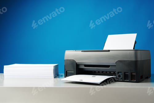 Preview: Laser printer on desk against blue background.