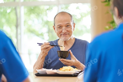 Preview: Elderly people having fun eating at a long-term care facility