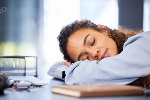 Preview: Cropped shot of an attractive young businesswoman sleeping on her desk in the office