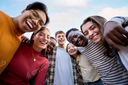 Preview: Portrait large group multiracial friends posing smiling and looking to camera. Happy young people