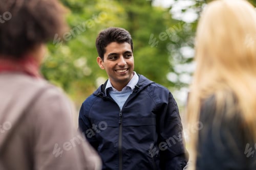 Preview: happy friends walking along autumn park