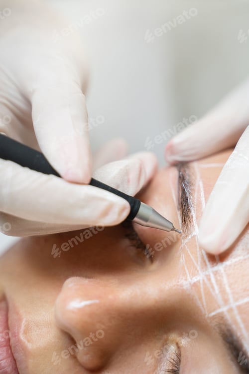 Preview: Woman during professional eyebrow mapping procedure