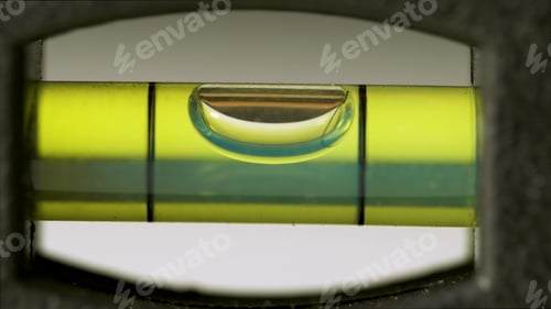 Preview: Spirit Level Close Up. Green bubble level isolated on a white background.