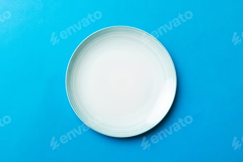 Preview: Top view of isolated of colored background empty round blue plate for food.
