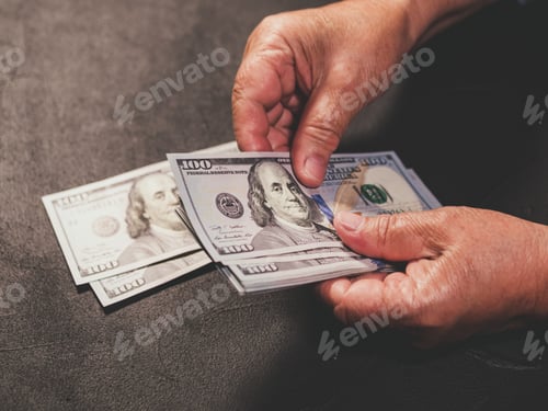 Preview: Counting US currency. Old woman counts money. New dollars in hands with wrinkles. Close up view.