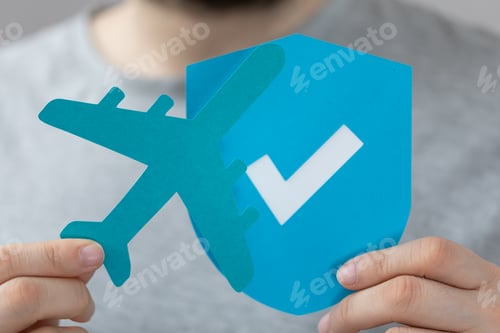 Preview: blue paper airplane and shield cut out held by a male
