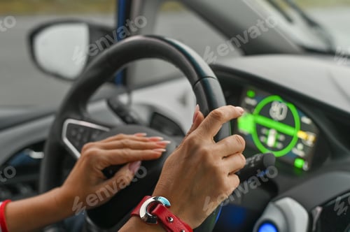Preview: a woman is driving a car. women's hands on the steering wheel.