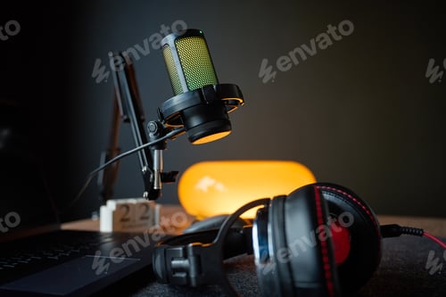 Preview: Microphone, headphones and laptop on desk in home recording studio