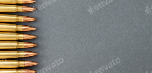 Preview: Bullets on gray paper background. Cartridges 7.62 caliber for Kalashnikov assault rifle
