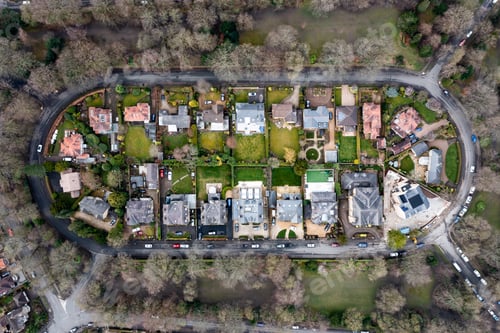Preview: Aerial view directly above an exclusive housing development with lush green lawns