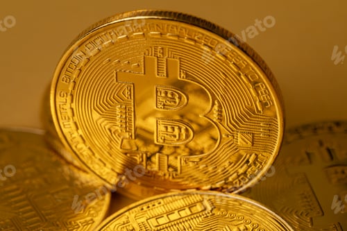 Preview: Closeup of gold bitcoin on yellow backgound