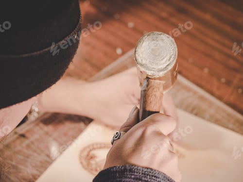 Preview: unrecognizable leather craftsman working on measurements in patterns in local workshop studio.