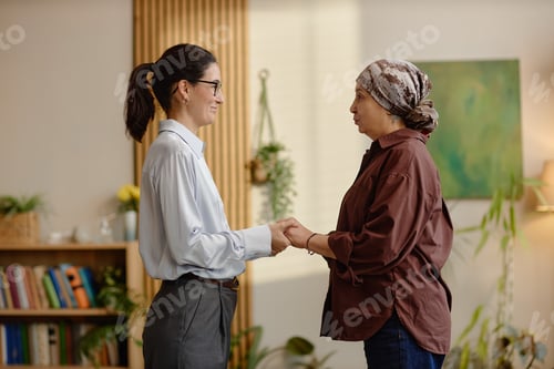Preview: Middle Aged Caucasian Woman Comforting Middle Aged Asian Woman during Counseling