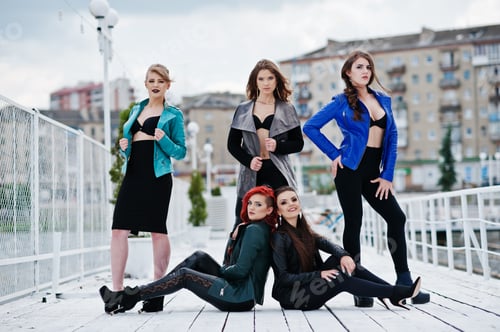 Preview: Group of sexy models girls in black bra and leather jackets on the dock