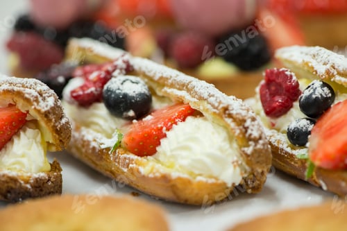 Fruit topped cream filled pastry delicacies close up