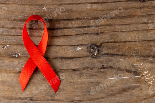 Preview: Image of red ribbon lying on wooden surface