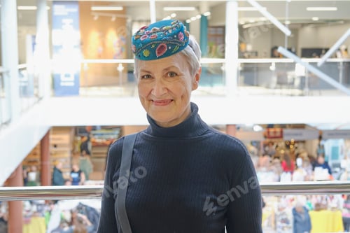 Preview: Senior woman wearing traditional Tatar embroidered scullcap with decorative embellishments.