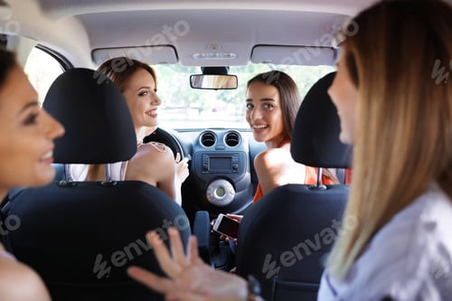 Preview: Happy beautiful young women together in car