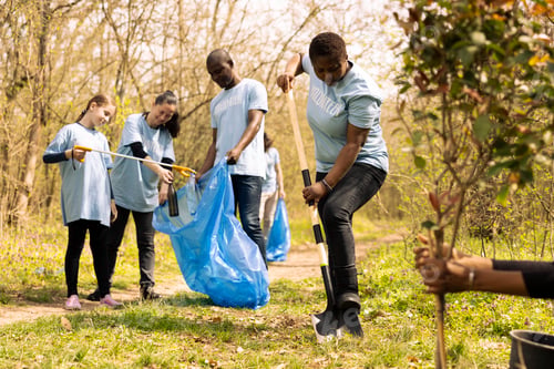 Preview: Diverse people cleaning up garbage in a disposal trash bag