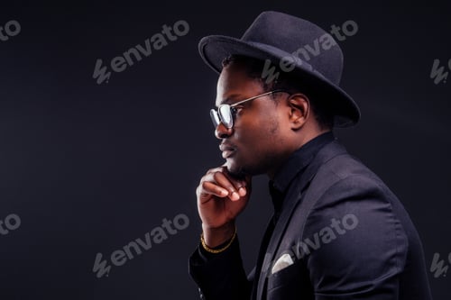 Preview: young handsome afro american melancholy boy in a jacket and glasses