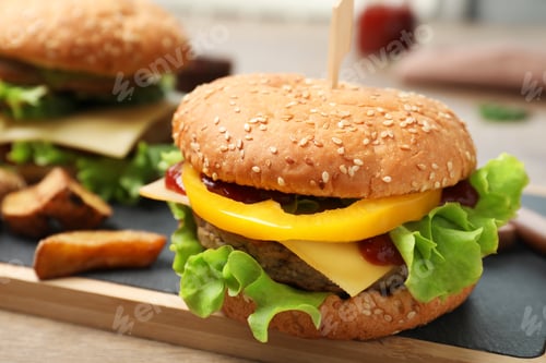 Preview: Board with delicious hamburger on table. Space for text