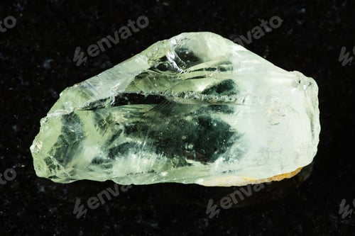 Preview: sample of raw prasiolite mineral on black granite