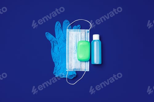 Preview: Coronavirus prevention. Facial mask, gloves, soap and sanitizer on blue background