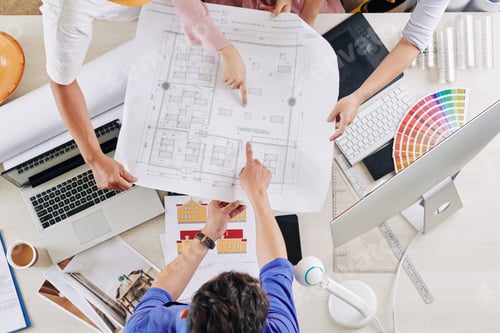Preview: Architects pointing at blueprint