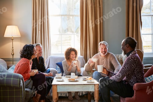 Preview: Group Of Middle Aged Friends Meeting Around Table In Coffee Shop