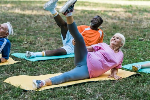 Preview: senior african american man and woman working out on fintess mats