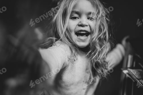 Preview: portrait of a emotional naughty little joyful girl, concept photo, selective focus, black and white