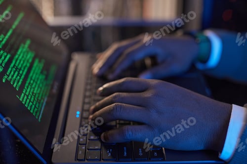 Preview: Typing Code on Laptop with Green Text Displayed