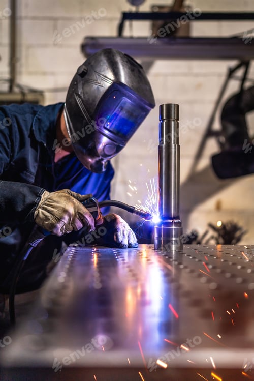 Preview: Welder with protective gear working in a factory