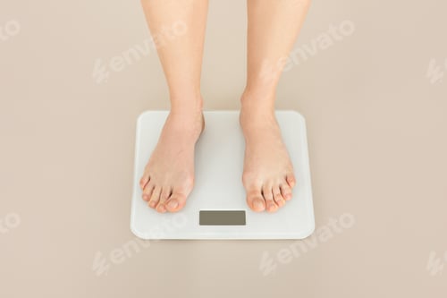 Preview: Feet on a White Scale on Beige Background