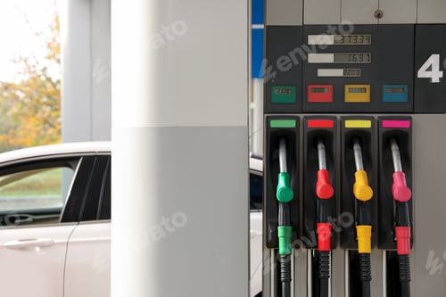 Preview: Petrol pump filling nozzles at gas station