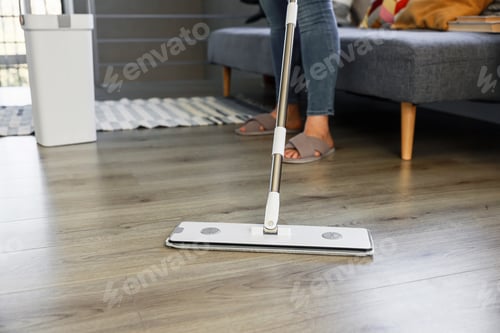 Preview: Woman mopping, wiping floor in home setting. Housewife uses mop, plastic bucket