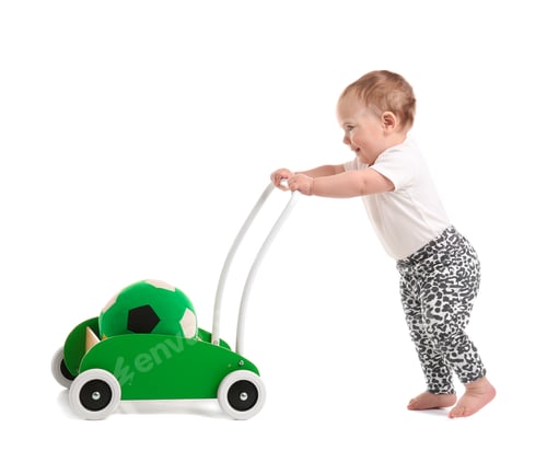 Preview: Cute baby with toy walker on white background