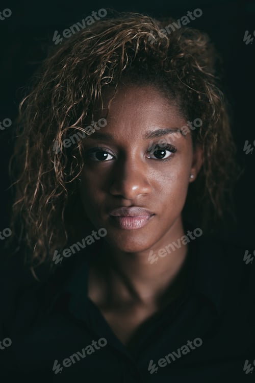 Preview: Portrait of attractive young woman in front of black background