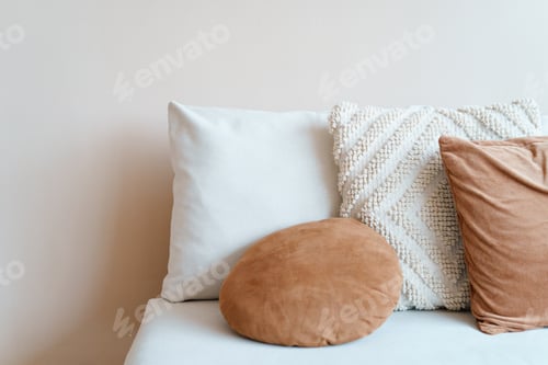 Preview: Pillows on a Couch Against White Wall