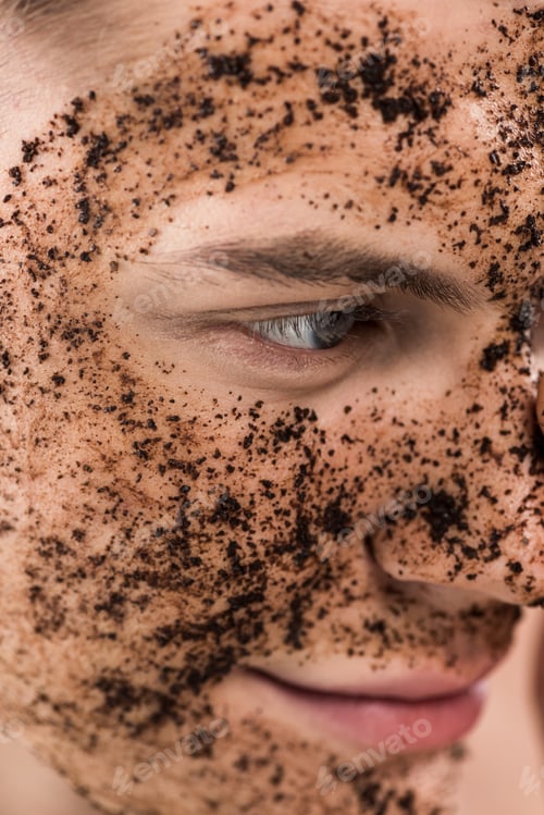 Preview: cropped view of young man with scrub on face