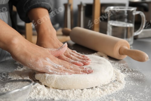 Preview: Woman kneading dough for pastry on table